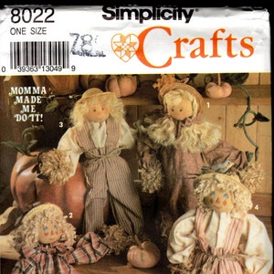 May include: A Simplicity Crafts pattern for making four scarecrow dolls. The pattern includes instructions for making the dolls with different fabric patterns and accessories. The dolls are dressed in plaid, striped, and solid fabrics. The pattern also includes instructions for making a bird to place on one of the dolls' hats. The pattern is titled "Momma Made Me Do It!"