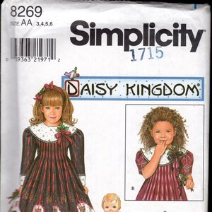 May include: Simplicity sewing pattern number 1715 for a Daisy Kingdom dress. The pattern includes instructions for a dress for a child and a bonus doll dress pattern. The pattern is for sizes 3, 4, 5, and 6.