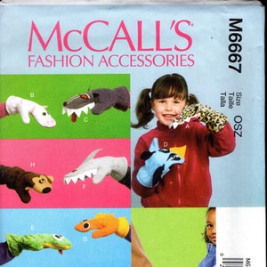 May include: McCall's Fashion Accessories pattern featuring various animal-themed hand puppets. The puppets include a white horse, a shark, a monkey, a leopard, a blue bird, and a green lizard. The pattern is size OSZ.