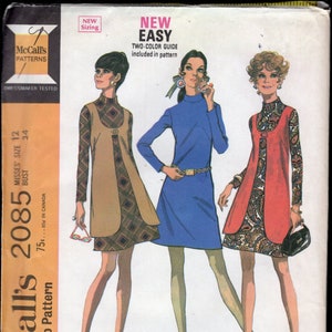 May include: Vintage McCall's sewing pattern for Misses' dress and vest. The pattern features three illustrated women wearing different dress and vest combinations. The pattern includes a two-color guide and is labeled "New Easy".