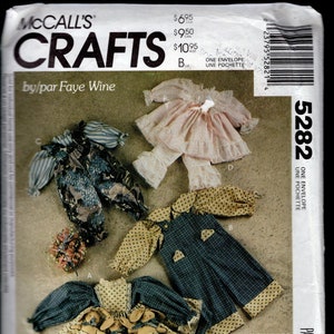 May include: McCall's Crafts pattern for bunny wraps. The pattern includes instructions for making clothes for country rabbits. The image shows several outfits, including a blue and yellow dress, overalls, and a pink outfit. The pattern is for rabbits 14, 20, and 25 inches in size.