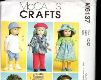 May include: A McCall's Crafts sewing pattern featuring six dolls in various outfits. The dolls are dressed in a baseball uniform, houndstooth jacket and red pants, a floral dress, and more. The pattern includes the text "MCCALL'S CRAFTS" and "M6137".