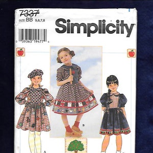 May include: Simplicity sewing pattern for girls' dresses, sizes 5, 6, 7, and 8. The pattern features three dress designs with various patterns and details. The package includes the text "Appletree" and a barcode.