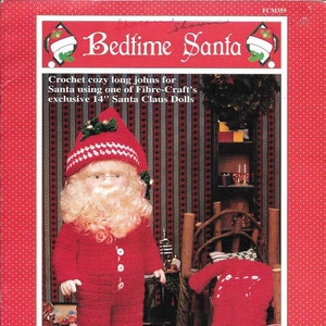 May include: A red crochet Santa Claus doll wearing a matching red hat and pajamas. The doll has a white beard, glasses, and is holding a red robe. The image is from a Fibre-Craft pattern for a 14-inch doll.