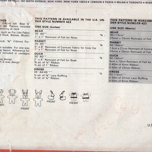 May include: A Butterick sewing pattern envelope back for stuffed animals and clothes, pattern number 200. It includes text detailing fabric requirements, notions, and sizes in inches and centimeters, alongside line drawings of a bear, rabbit, and duck.