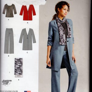 May include: Simplicity sewing pattern 1073. The pattern features a woman's suit with a long jacket, pants, and a scarf. The pattern also includes a top and a coat. The suit is shown in a blue color.