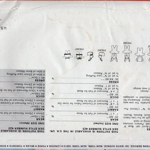 May include: A white paper sewing pattern envelope for stuffed animals and clothes, featuring line drawings of a bear, rabbit, and duck. The back includes fabric requirements in inches and centimeters, a barcode, and the text Butterick Pattern Service.