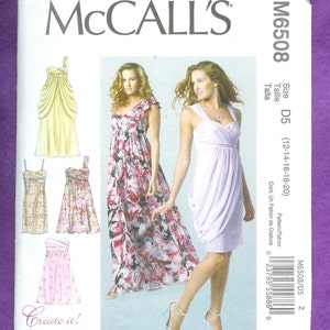 May include: A sewing pattern for a dress with a draped bodice and a flowing skirt. The pattern includes three different styles: a short dress with a floral print, a long dress with a floral print, and a long dress with a solid color. The pattern is for sizes 12-14-16-18-20. The pattern is called McCall's M6508.