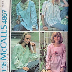 May include: Vintage McCall's sewing pattern 4867 featuring four different top designs. The tops are in various colors, including blue, pink, and green, with details like floral embroidery and striped patterns. The pattern includes extra cut-lines for maternity fit.