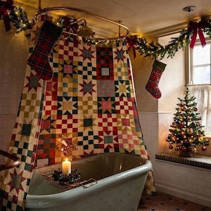 May include: A bathtub with a patchwork shower curtain featuring red, green, and cream star and checkerboard patterns. Two plaid Christmas stockings hang from a garland above the tub. A lit candle sits on a metal tray across the bathtub.