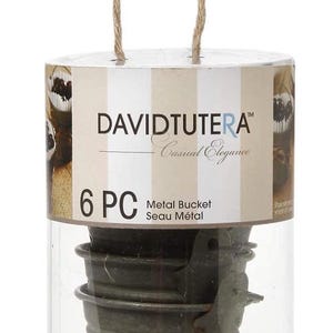 May include: A set of six small, weathered metal buckets with a rope handle, packaged in a clear plastic cylinder. The packaging includes the text "DAVIDTUTERA Casual Elegance" and "6 PC Metal Bucket Seau Métal".