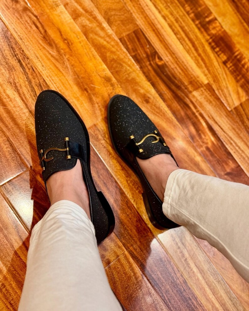 Premium handmade men’s dress loafers in black glitter finish with gold bit accent and modern sophisticated style.