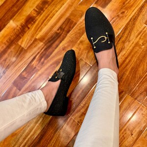 Handmade black sparkle loafers for men featuring gold metal buckle and sleek formal slip-on shoe design.