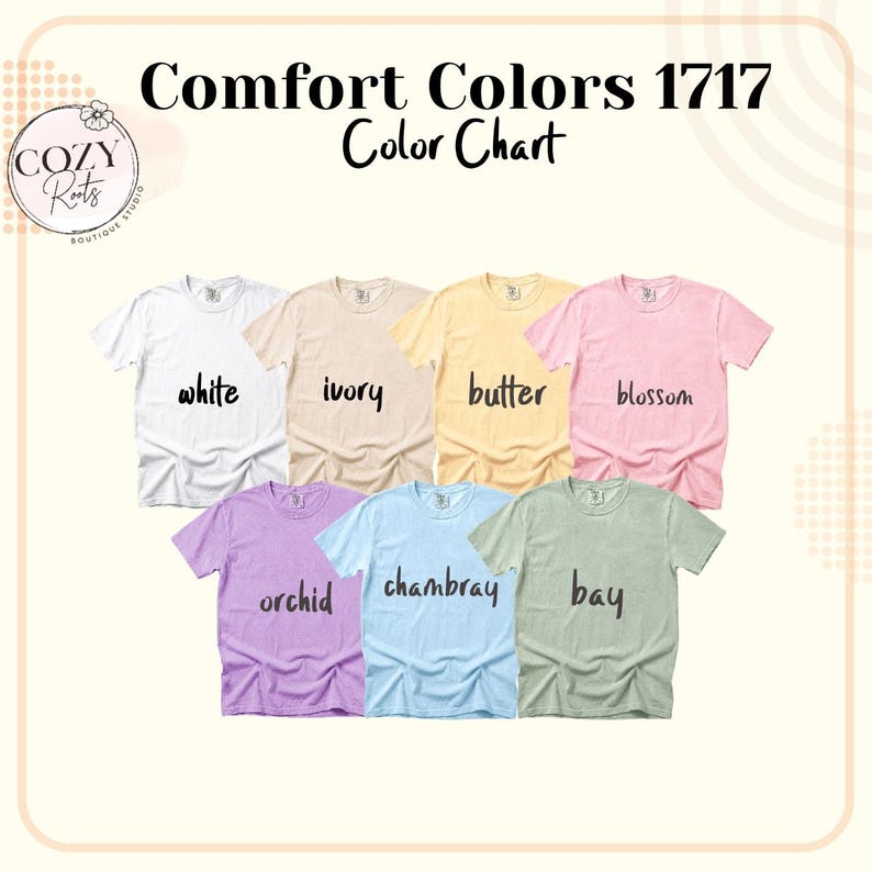 May include: A Comfort Colors 1717 colour chart featuring seven short-sleeve t-shirts in white, ivory, butter, blossom, orchid, chambray, and bay. The text Comfort Colors 1717 Colour Chart is displayed at the top with a Cozy Roots logo in the corner.