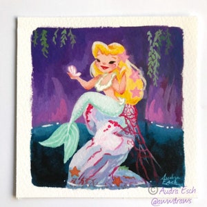May include: A mermaid with long blonde hair sits on a pink and white rock, holding a white seashell. The background is a dark purple with green seaweed hanging down. The mermaid has a green tail and is wearing a white seashell bra.