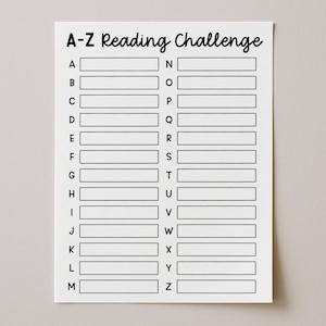May include: A white paper sheet featuring a black printed A-Z Reading Challenge tracker. The layout includes the title at the top followed by two columns of letters from A to Z, each paired with a blank rectangular box for writing book titles.
