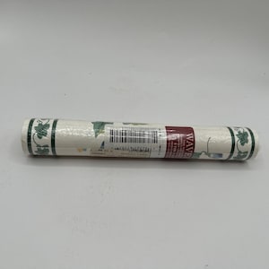 May include: Rolled wallpaper border featuring a repeating pattern of green leaves and blue flowers on a cream background. The border is trimmed with a dark green edge. The label reads "WAVE".