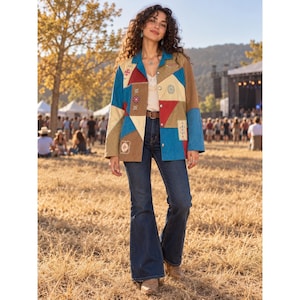May include: A long-sleeve button-down jacket featuring a patchwork design with triangular and rectangular panels in shades of blue, red, tan, and cream. The jacket includes embroidered circular and rectangular motifs and is worn over a white top and dark blue denim flare jeans with a brown leather belt.