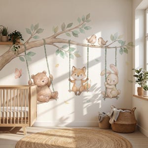 May include: A wall decal featuring a large tree branch with green leaves, two small birds, and three rope swings. A brown bear, a fox, and a rabbit sit on the swings. A pink butterfly is visible near the bear, and falling leaves are scattered.