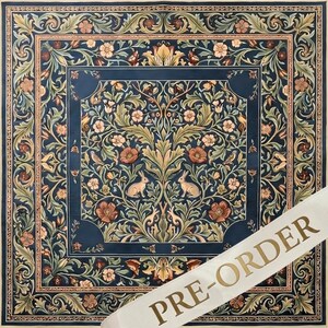 May include: A square textile featuring a dark blue background with a symmetrical pattern of light brown rabbits, green foliage, and pink flowers. A wide decorative border frames the central design. A white diagonal banner displays the text PRE-ORDER.