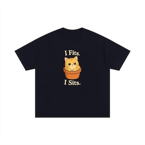 May include: A black short-sleeved t-shirt featuring a graphic of an orange tabby cat sitting inside a brown terracotta flower pot. Above the cat is the text "I Fits." and below the cat is the text "I Sits." in a cream-coloured serif font.