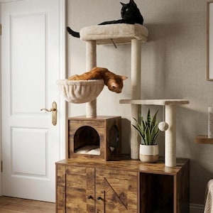 May include: A multi-level cat tree with a dark brown wooden cabinet base and multiple platforms. A black cat rests on the top platform, while an orange cat lounges in a hanging bed. The cat tree includes scratching posts and a small plant.