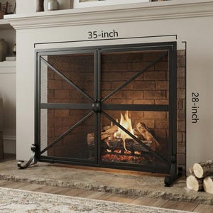May include: A black metal fireplace screen with a double-door design, featuring a fine mesh panel and diagonal crossbar detailing. The screen measures 35 inches in width and 28 inches in height, positioned in front of a brick fireplace interior.
