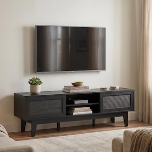May include: A black rectangular media console with two side cabinets featuring mesh door panels and a central open shelving unit. The console stands on four short legs and is positioned against a wall beneath a large flat-screen television.