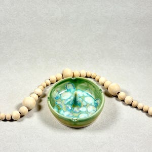 May include: A rustic wooden sign with the text "Welcome to our home" in white lettering. The sign features a distressed finish and a simple, inviting design, perfect for entryway decor.