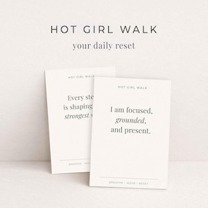 May include: Two white cards with the text "HOT GIRL WALK" and "your daily reset". One card reads "Every step is shaping strongest s". The other card reads "I am focused, grounded, and present."