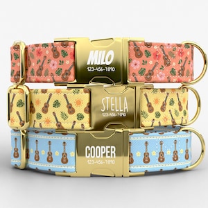 May include: Three pet collars with gold-tone metal buckles engraved with names and phone numbers. The top collar is coral with ukuleles and hibiscus flowers, the middle is yellow with ukuleles and suns, and the bottom is light blue with ukuleles.