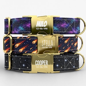 May include: Three personalized dog collars with gold-colored buckles. The top collar has a galaxy design, the middle one features shooting stars, and the bottom one has a starry night pattern. Each buckle displays a name and phone number.