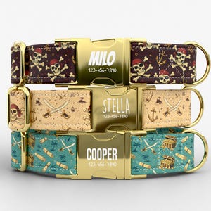 May include: Three personalized dog collars with gold-colored buckles. The top collar is dark brown with a pirate skull and crossbones pattern. The middle collar is tan with a map and crossed swords. The bottom collar is teal with treasure chests and scrolls. Each buckle has a name and phone number.