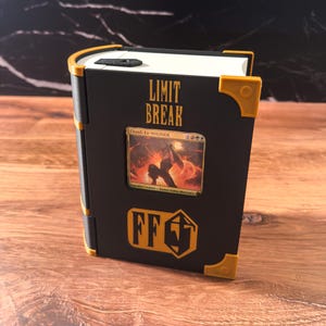 May include: Black book-shaped card holder with gold accents. The cover features the text "LIMIT BREAK" and a card image. The bottom has a gold FF logo. The edges are gold, and the book is open.