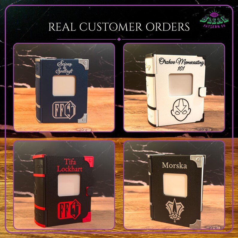 May include: Four rectangular book-shaped boxes with central square cutouts. The top left is blue with silver accents and text. The top right is white with black text and a character icon. The bottom left is black with red accents and text. The bottom right is black with silver accents and text.