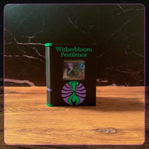 May include: A black rectangular deck box with a green spine and purple accents. The front features the text Witherbloom Pestilence in green, a circular purple and green emblem, and a central window displaying a holographic trading card.