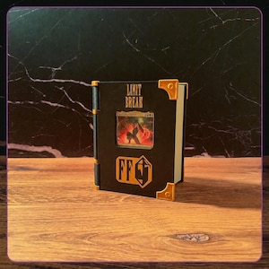May include: A black rectangular display case for a trading card, featuring the text LIMIT BREAK in gold lettering at the top and an FF logo at the bottom. The case has gold-colored corner accents and a central window displaying a card.