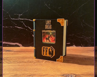 May include: A black rectangular display case for a trading card, featuring the text LIMIT BREAK in gold lettering at the top and an FF logo at the bottom. The case has gold-colored corner accents and a central window displaying a card.