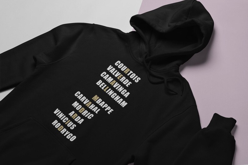 Real Madrid players lineup in their iconic white kits, standing side by side with a strong and determined presence. The backdrop captures the energy of the stadium, highlighting the unity and championship spirit of the team. Perfect for passionate Madridistas and football fans alike.