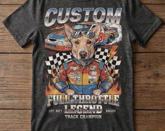 May include: Dark gray t-shirt featuring a dog wearing sunglasses and a racing jacket, with the text "CUSTOM" above the dog. The shirt also has racing cars and the words "FULL THROTTLE LEGEND TRACK CHAMPION".