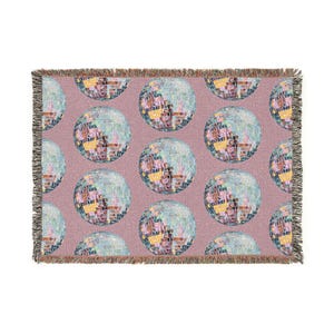 May include: A rectangular throw blanket featuring a repeating pattern of disco balls on a mauve background. The disco balls are a mosaic of colors, and the blanket has a fringed edge.