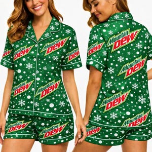 May include: Green pajama set with white trim, featuring the "Mountain Dew" logo in red and white, and a snowflake pattern. The set includes a short-sleeved button-up shirt and matching shorts.