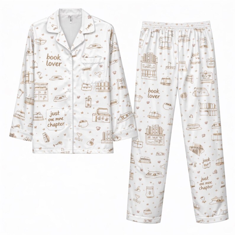May include: White pajama set with a brown book-themed pattern. The button-down shirt and pants feature illustrations of books, book stacks, and the phrases "book lover" and "just one more chapter."