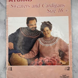 May include: A vintage Patons knitting pattern booklet titled "Sweaters and Cardigans Size 16 +". The cover features a photo of a man and woman wearing knitted sweaters. The booklet has a pink cover with text and illustrations.
