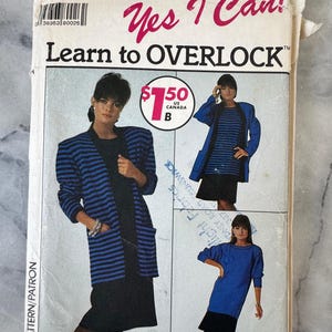 May include: A vintage Simplicity sewing pattern, number 9233, with the text "Yes I Can! Learn to OVERLOCK". The pattern shows a woman in a blue and black striped jacket and dress. Size NN (10-16).