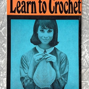 May include: A vintage book cover titled "Learn to Crochet" with black text on an orange background. The cover shows a woman crocheting a doily, set against a blue backdrop. The text at the bottom reads "Directions are included for left-handed workers."