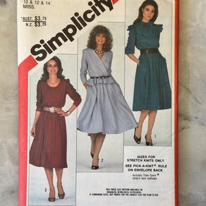 May include: A vintage Simplicity sewing pattern, size N, with three dress designs illustrated on the cover. The pattern features the Simplicity logo and number 5720. The dresses are shown in different colors. The pattern is for stretch knit fabrics.