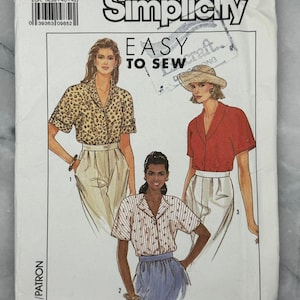 May include: Simplicity sewing pattern 9499. The pattern features illustrations of three different short-sleeved blouses. The text "EASY TO SEW" is displayed prominently. The pattern size is N (10+12+14).