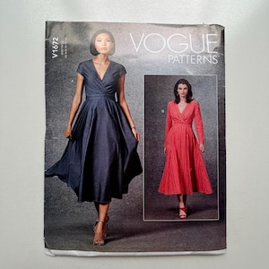 May include: Vogue Patterns sewing pattern featuring two dress designs. One dress is a dark blue wrap dress with short sleeves. The other dress is a red long-sleeved dress with vertical stripes. The pattern number is V1672.