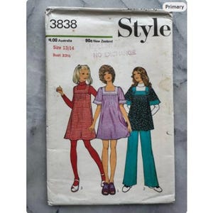 May include: A vintage "Style" sewing pattern featuring illustrations of three women in dresses and a pantsuit. The pattern cover displays the number "3838", size details, and the bust measurement. The cover is slightly worn.